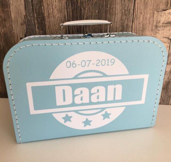 Blauw logeerkoffertje bedrukt met stempel en geboortegegevens